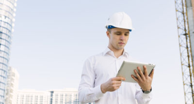 medium-shot-young-man-with-helmet-tablet