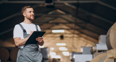 Young handsome man working at a factory